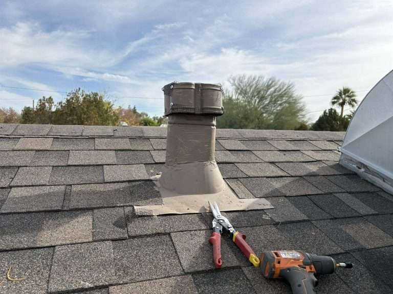 Roof vent sealed with wire mesh, with tin snips and a drill on the shingles